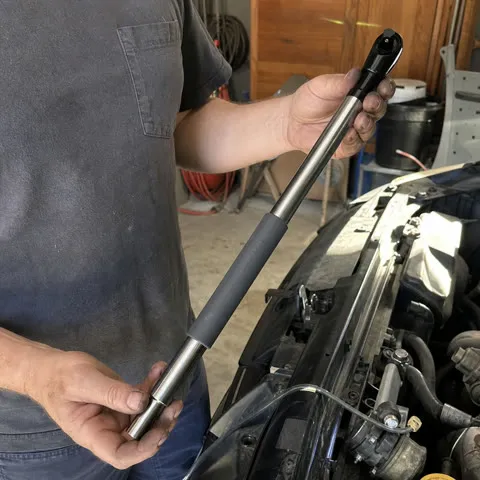 Customer using the offset ratchet extension in a home garage