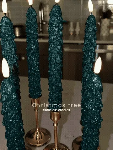 Remote-controlled Christmas tree candles glowing in a holiday display