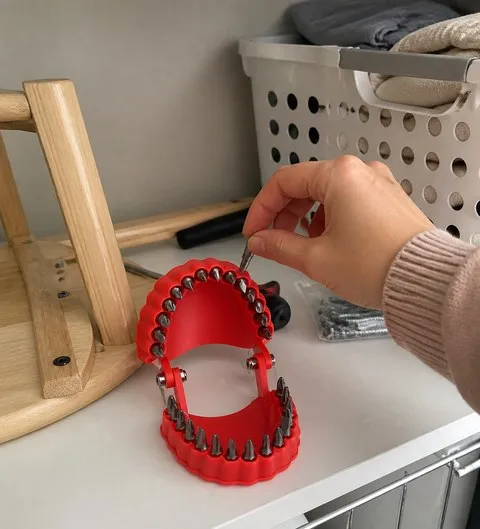 A hand choosing a bit beside a small home furniture project