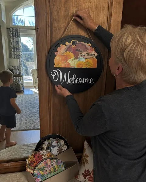 Fall welcome sign being hung in a family home