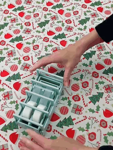 Expandable tape strip dispenser being set up and used for gift wrapping