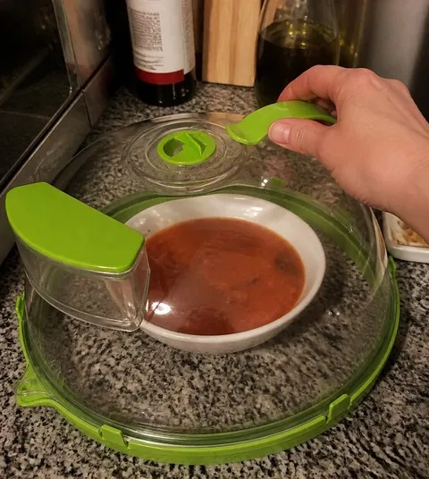 Microwave cover over a bowl of soup in a home kitchen