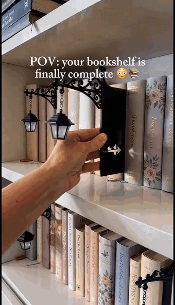 Bookshelf insert sliding between books and lighting in vintage lantern and reading ghost styles