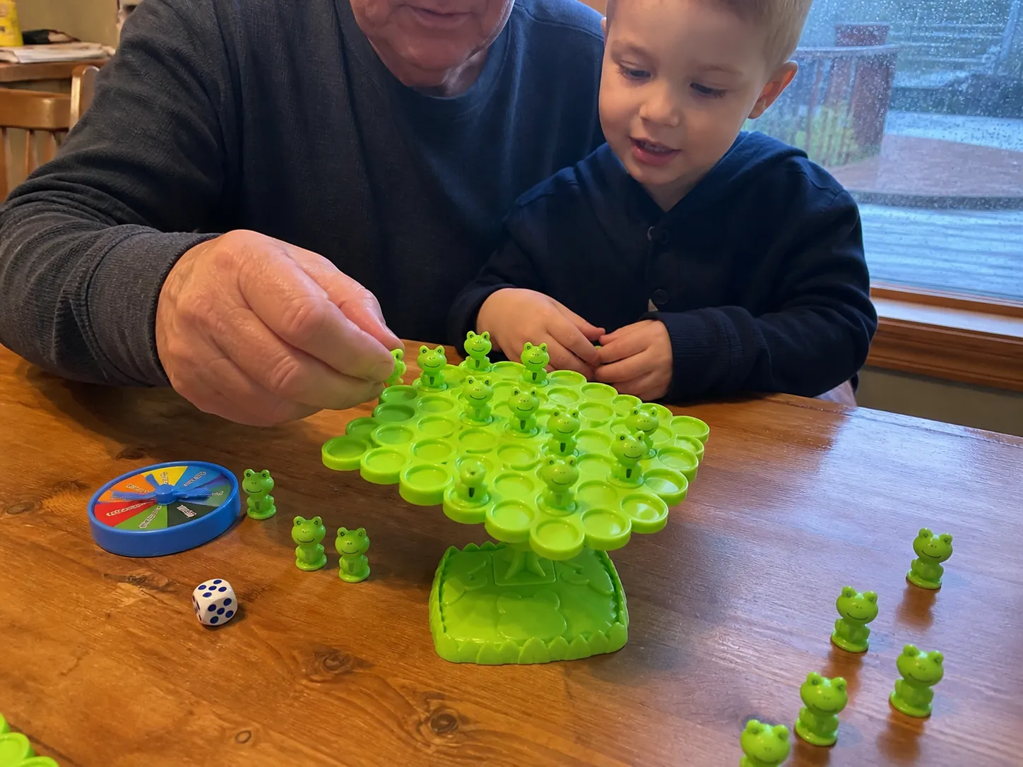 Grandparent and child playing the frog balance game