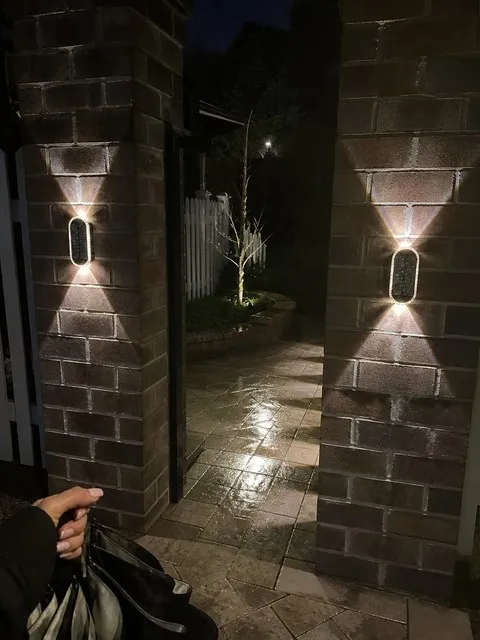 Outdoor solar wall lights in a customer's home setting
