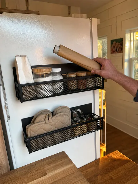 Baking supplies in black magnetic racks on a refrigerator