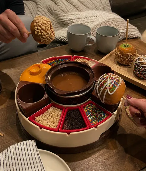 Couple making decorated apples for a cozy movie night