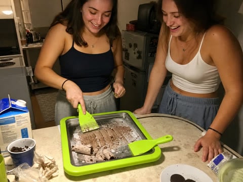Roommates making chocolate cookie ice cream
