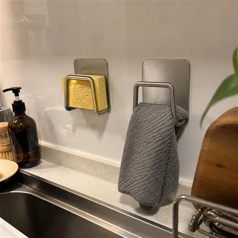 Two silver holders organizing a sponge and cloth