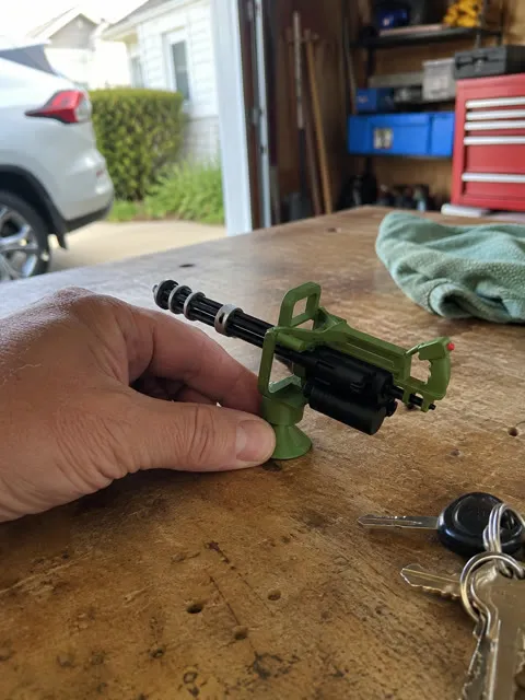 Army green ornament on a garage workbench beside car keys