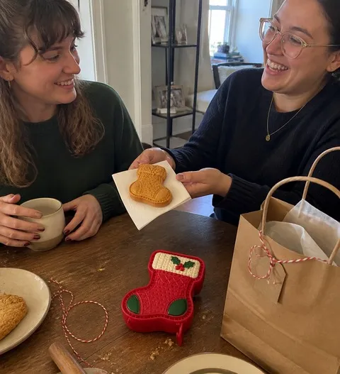 Friends sharing a homemade Christmas-stocking mini pie