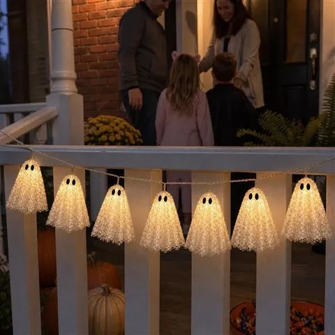 Warm white lace ghost lights on a porch railing during trick or treat night