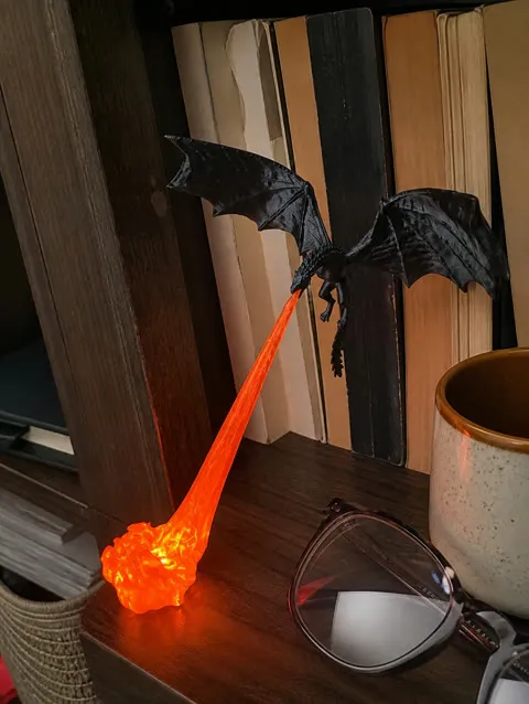 Red glow dragon decoration on a lived-in home bookshelf