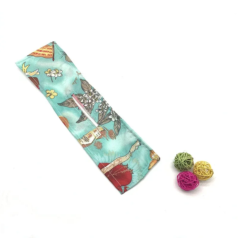 Green floral print hair accessory shown flat