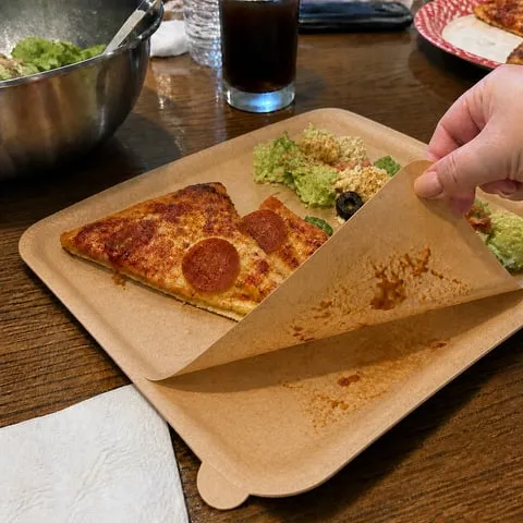 Square layered peel-away plate used for a family pizza dinner