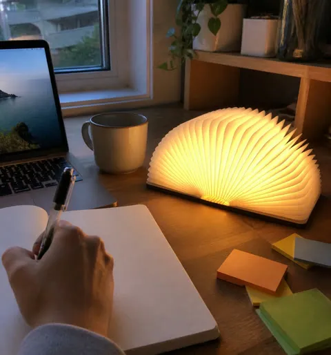 Book light glowing on an everyday apartment desk