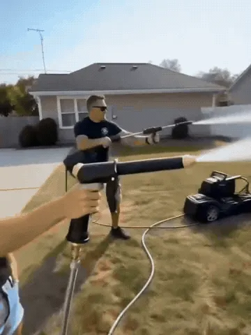 Portable water sprayer cleaning a yard, outdoor steps and grill
