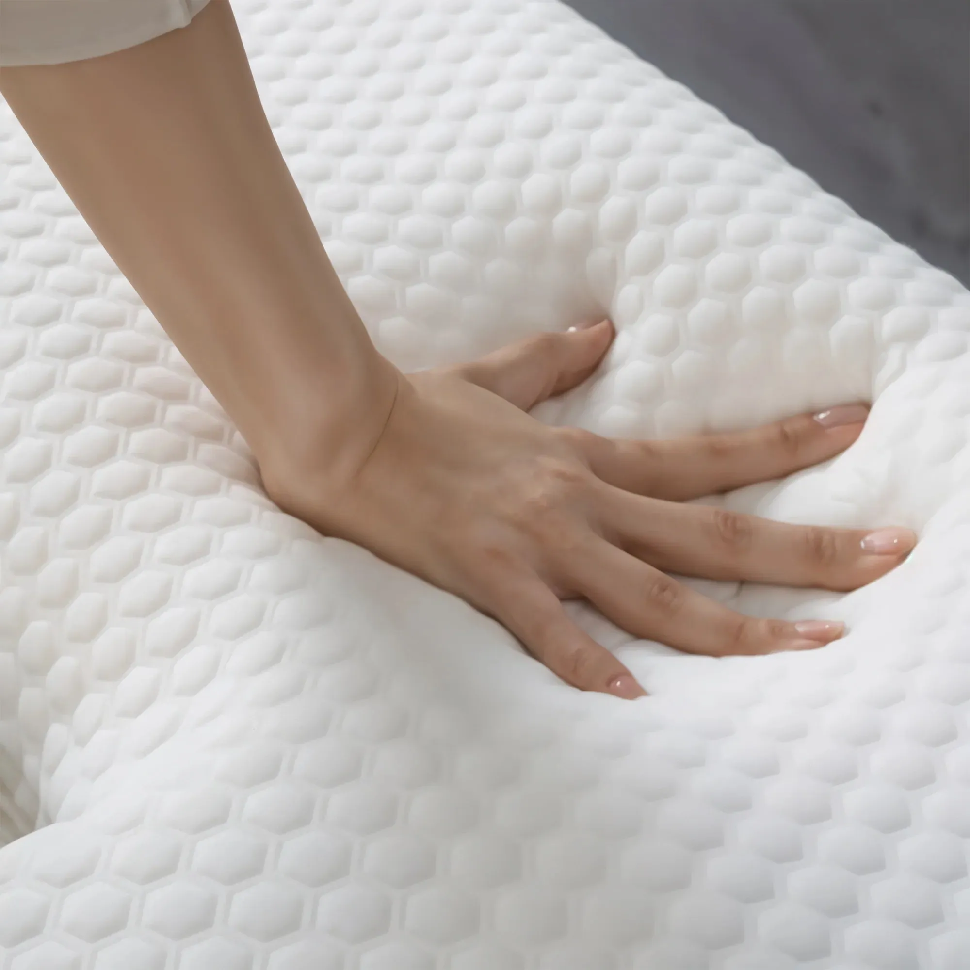 Hand pressing the slow-rebound memory foam pillow surface