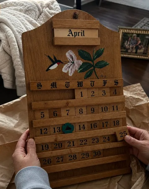 A wooden calendar being unwrapped as a home gift