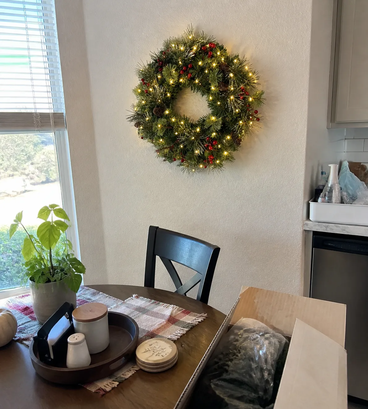Lit wreath in a casual kitchen dining nook