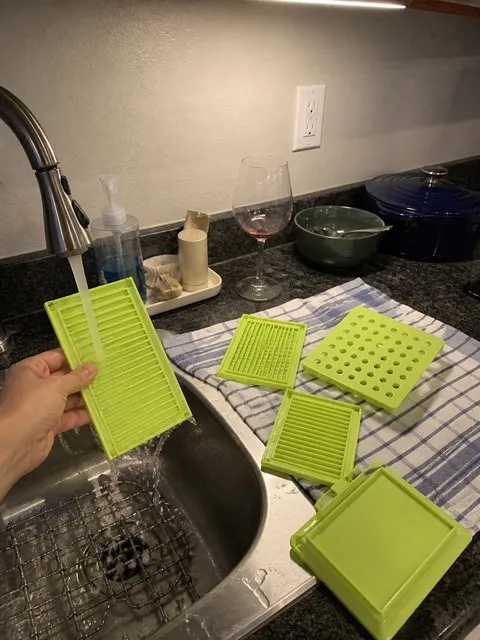 Kebab maker panels being rinsed at a sink