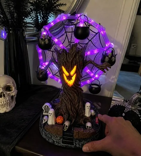 Haunted tree Ferris wheel glowing on a casually decorated entryway console