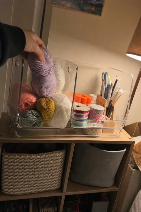 Clear organizer bins holding craft supplies
