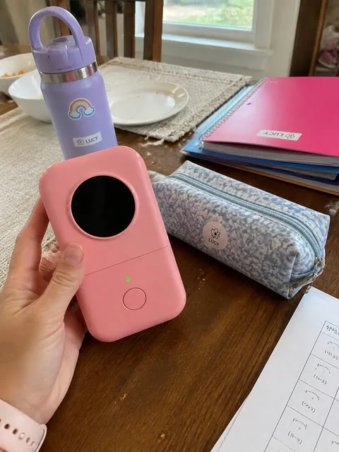 Pink label printer with organized school supplies