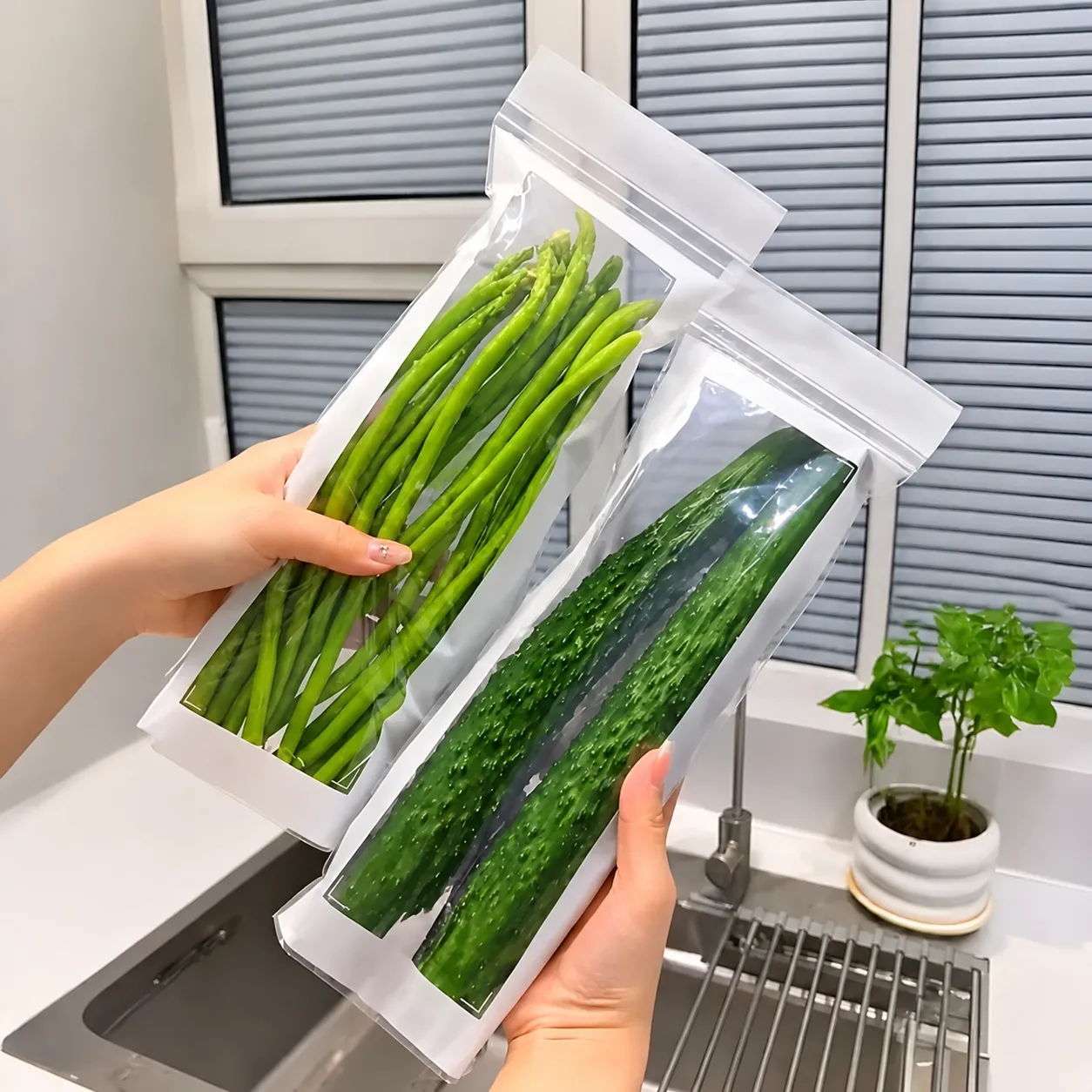 Two clear long produce bags holding asparagus and cucumbers