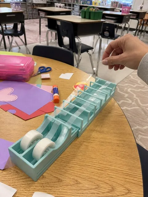 Green tape strip dispenser on a classroom craft table