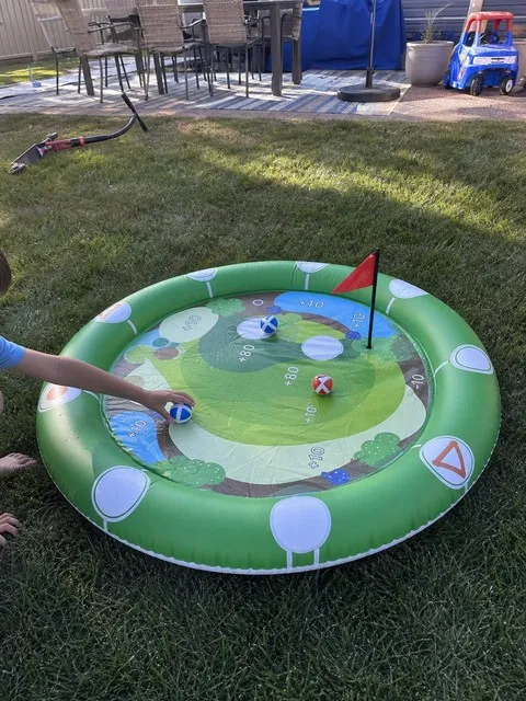 Family collecting sticky balls from the golf target on a backyard lawn