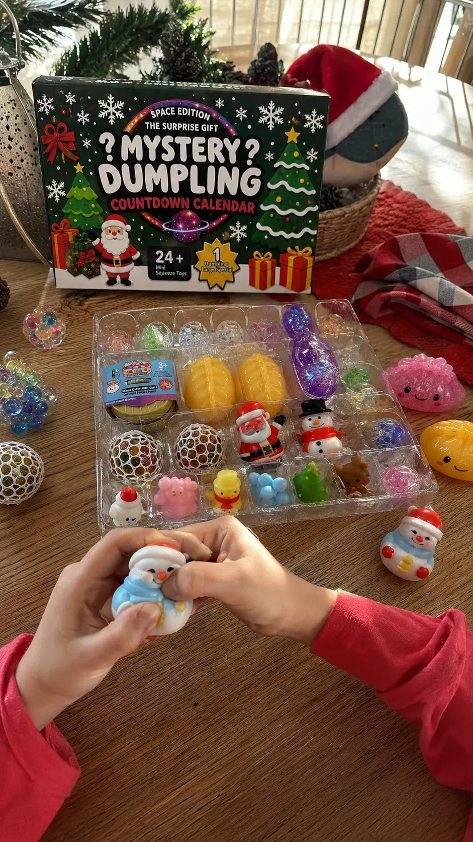 Customer-style vertical photo of child squeezing a Christmas surprise toy beside the countdown calendar