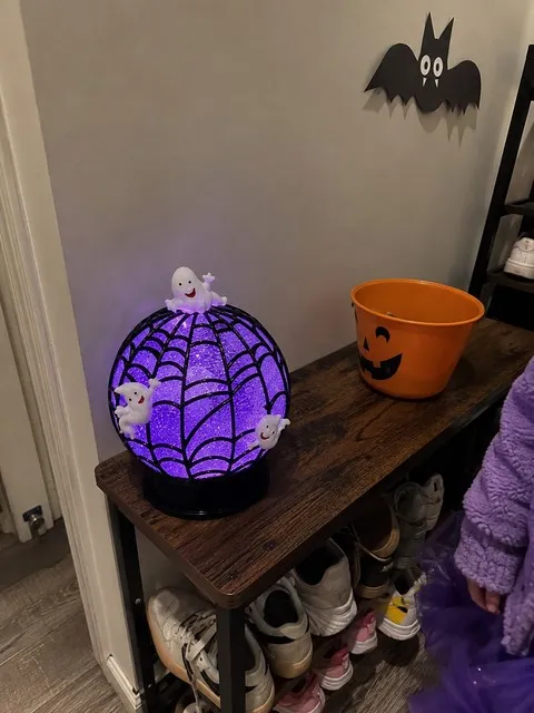 Ghost glitter globe on an apartment entryway bench