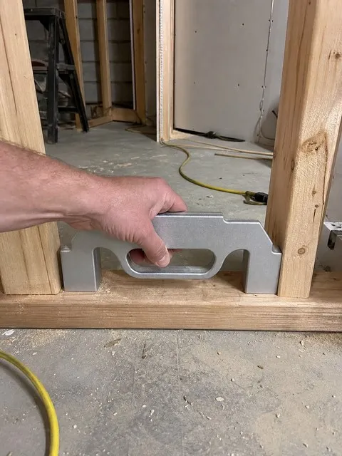 Basement renovation with a silver framing layout tool