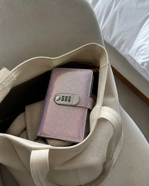 Compact purple lockable savings binder in a tote bag