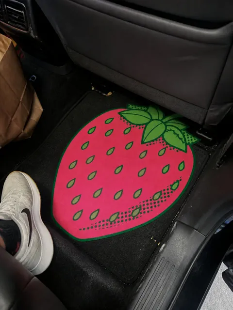 Casual customer-style photo of the strawberry mat in an SUV