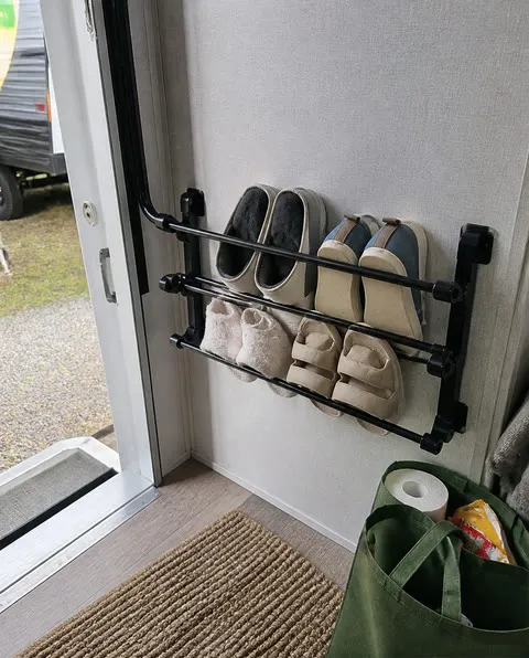 Wall shoe rack beside an RV doorway