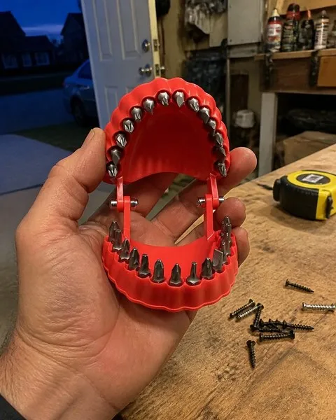 Open red bit organizer photographed on a home garage workbench