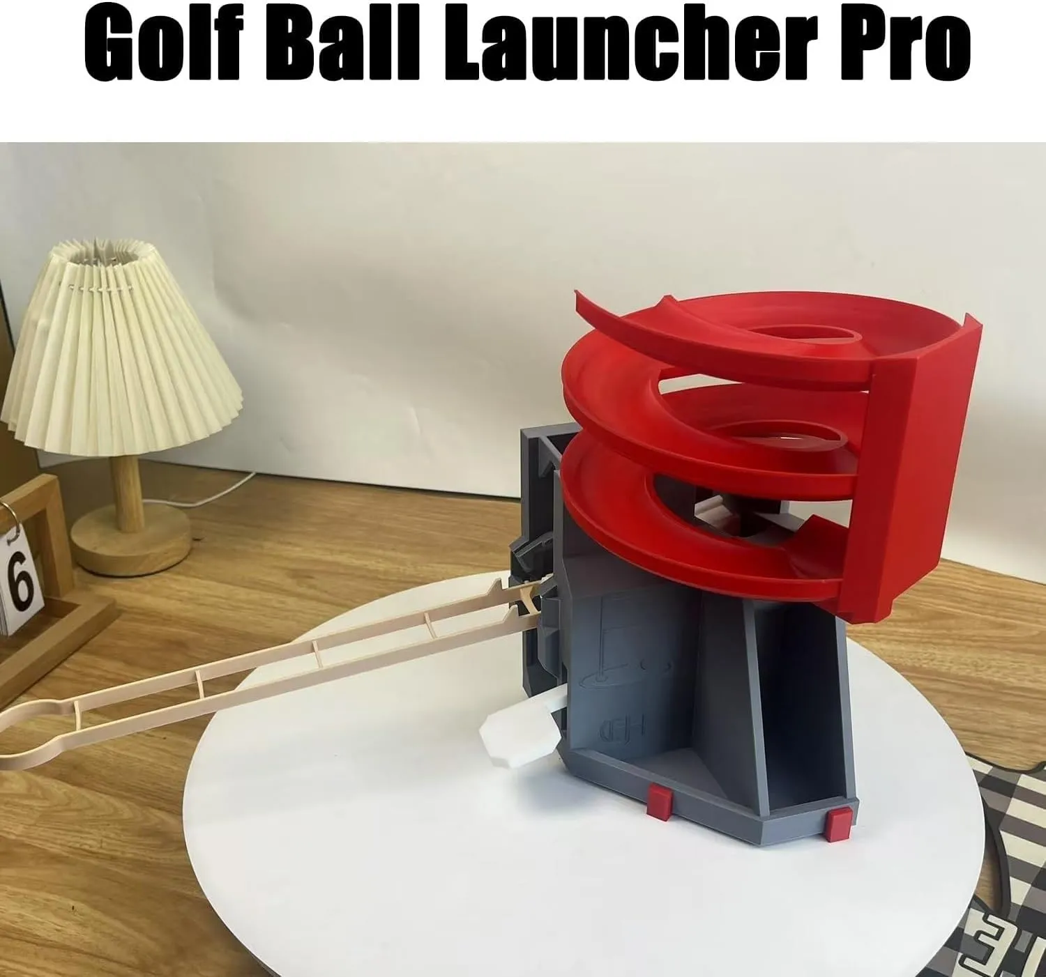 Close view of the red and charcoal golf ball dispenser mechanism