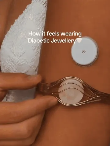 Gold open-cuff bracelet being positioned around an upper-arm sensor