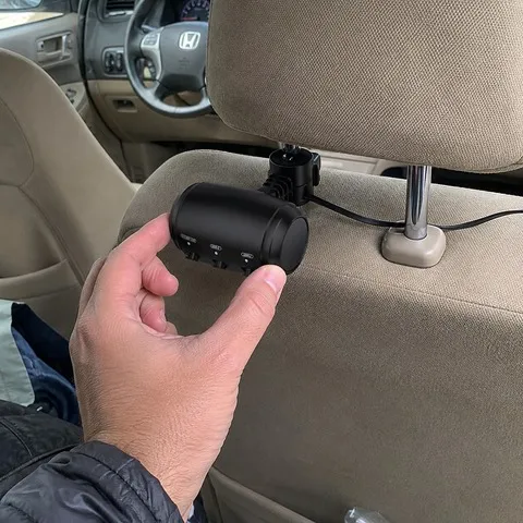 Charger being adjusted on a beige headrest
