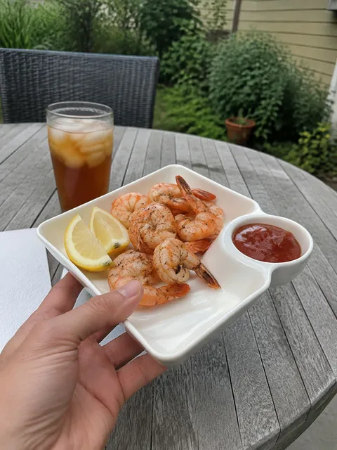 Shrimp and cocktail sauce served on a backyard patio