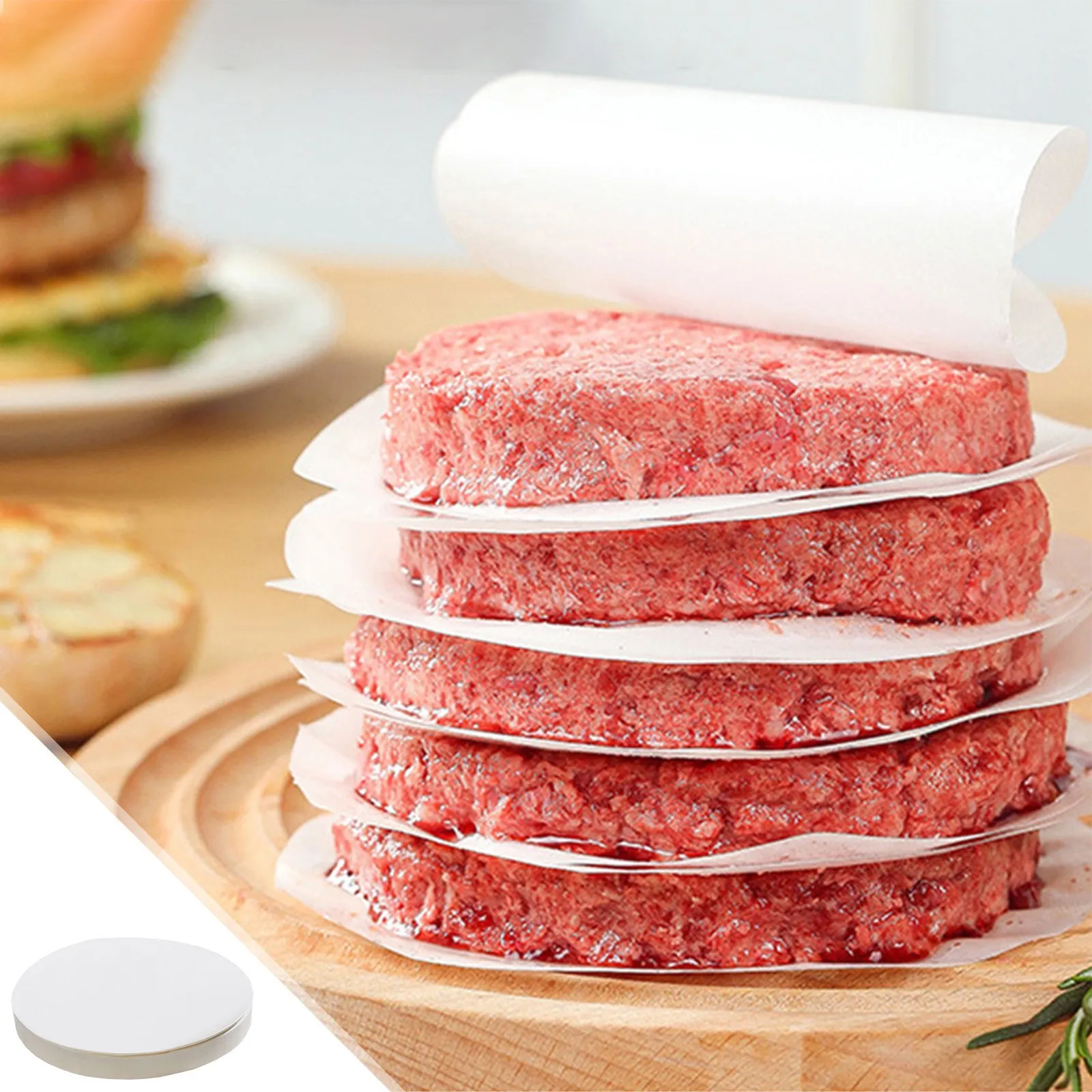 Evenly formed hamburger patties stacked with round separators