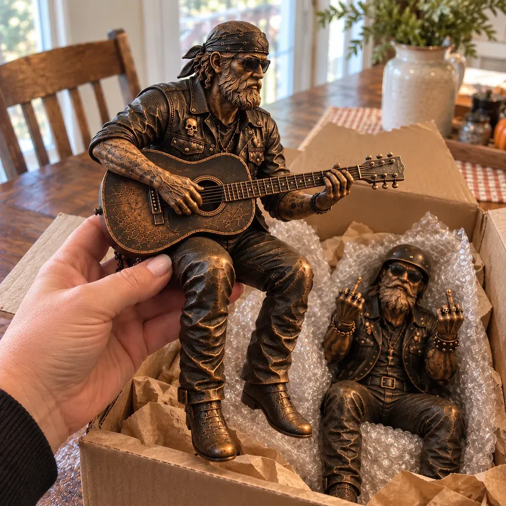 Close view of the Roadside Guitarist figurine and its sculpted clothing and guitar
