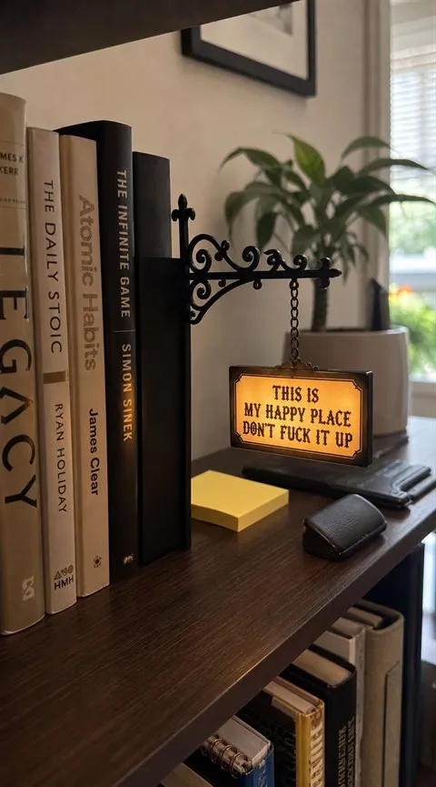 Happy Place Sign glowing on a home-office bookshelf