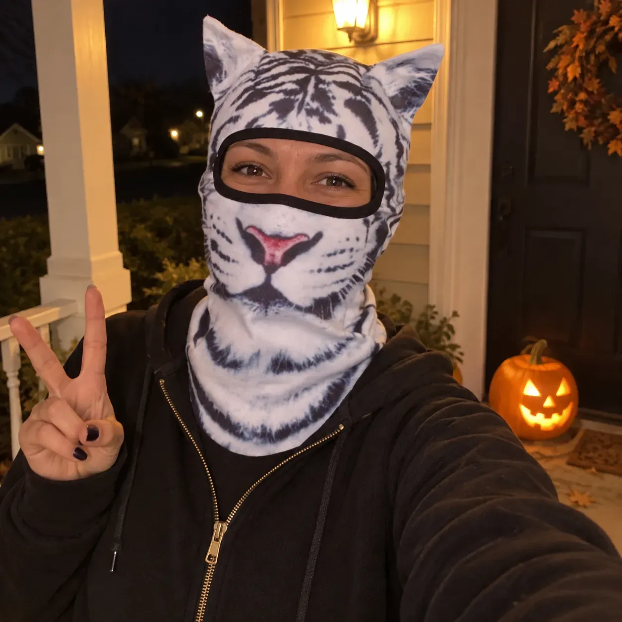 White tiger animal hood worn on a Halloween front porch
