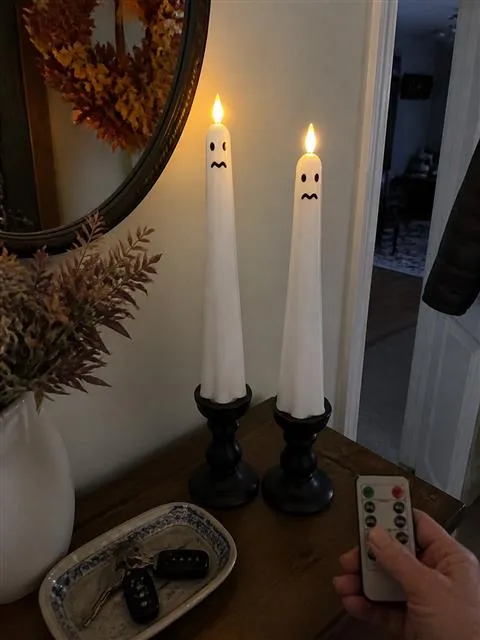 Crying face ghost candles controlled in an entryway