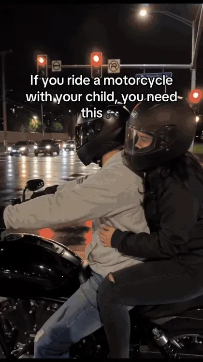 Adult motorcycle passenger using the waist-mounted dual-grip handle during a demonstration Adult motorcycle passenger using the waist-mounted dual-grip handle during a demonstration