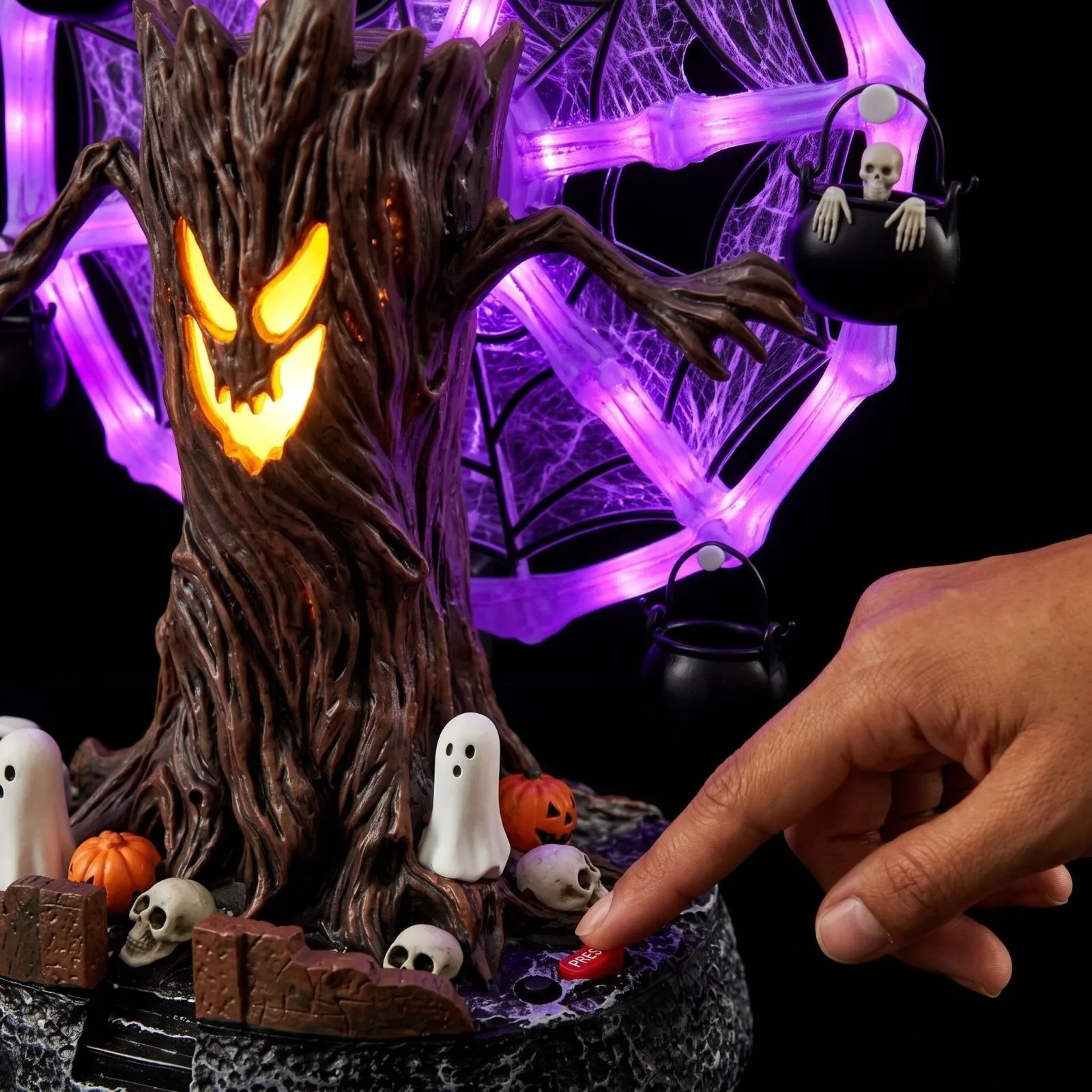 Close-up of the haunted tree face, spiderweb wheel, skeleton cauldron and base control