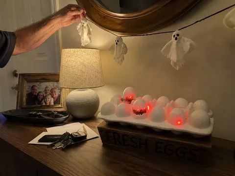 Glowing egg decoration on a lived-in entryway console